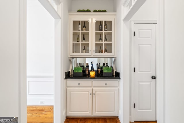 bar featuring white cabinets