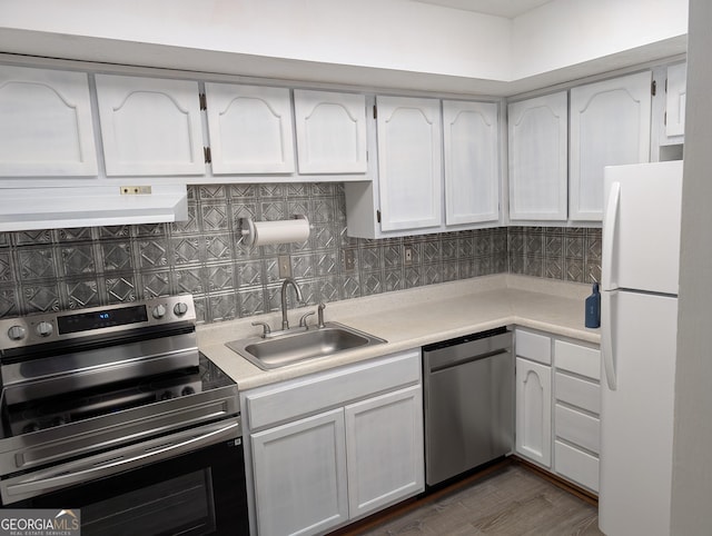 kitchen featuring stainless steel appliances, custom exhaust hood, a sink, white cabinets, and light countertops