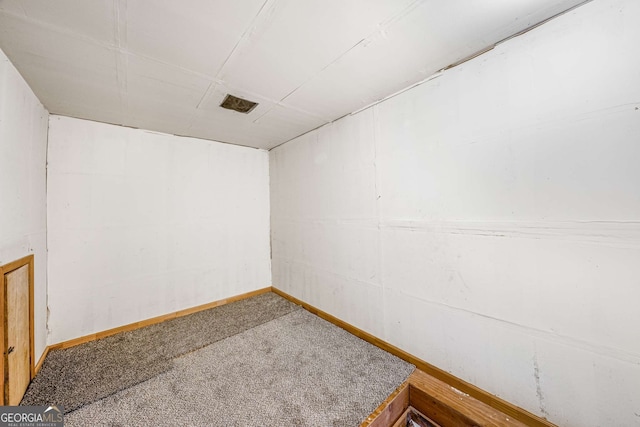 unfurnished room featuring carpet floors and baseboards