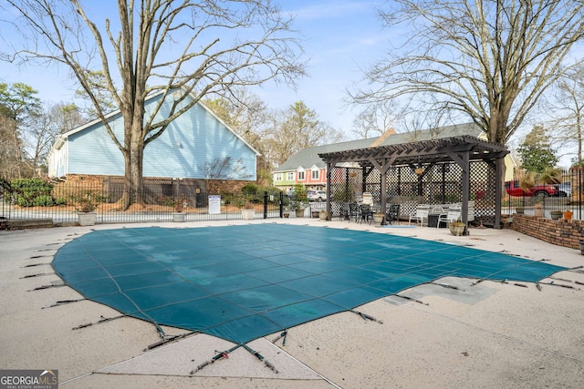 community pool featuring fence and a patio