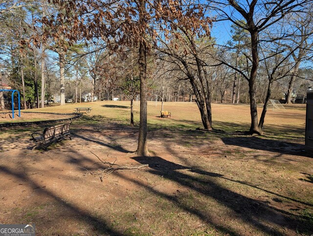 view of community with a playground and a yard