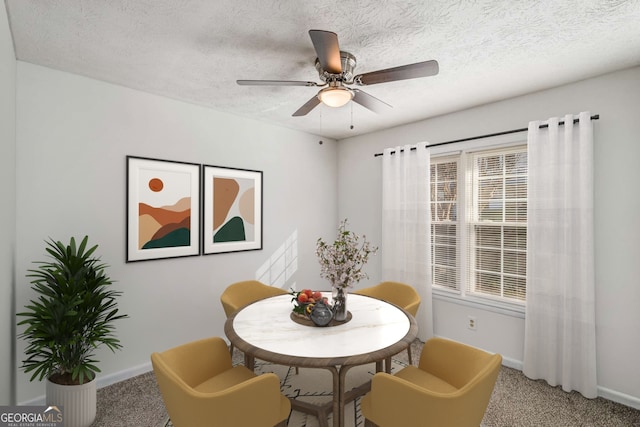 carpeted dining space with baseboards, ceiling fan, healthy amount of natural light, and a textured ceiling