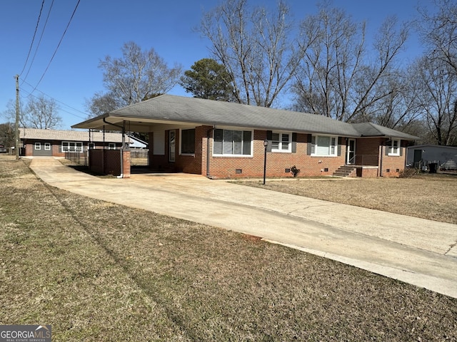 ranch-style home featuring concrete driveway, brick siding, and crawl space