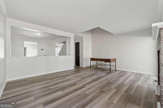 spare room with hardwood / wood-style flooring and crown molding