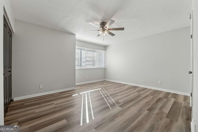 unfurnished bedroom featuring a textured ceiling, hardwood / wood-style flooring, and ceiling fan