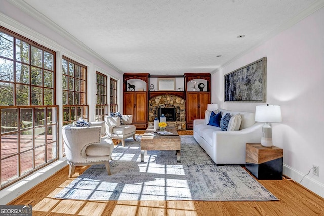 living room with a textured ceiling, wood finished floors, and crown molding