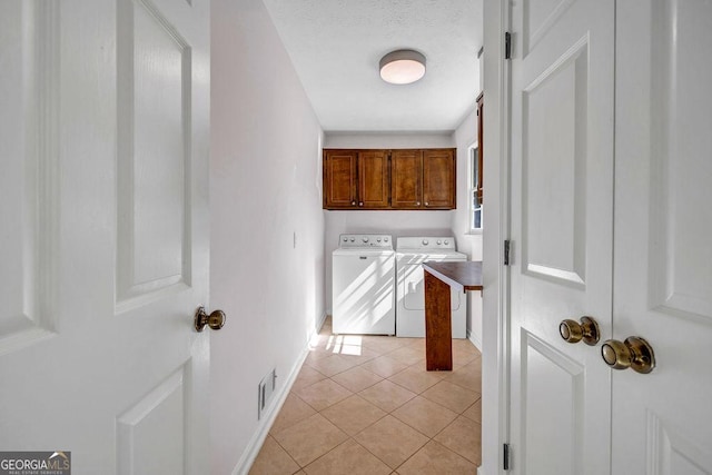 laundry room with cabinet space, visible vents, light tile patterned flooring, a textured ceiling, and independent washer and dryer