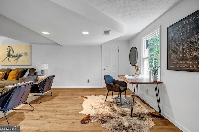 office space featuring recessed lighting, wood finished floors, visible vents, and baseboards