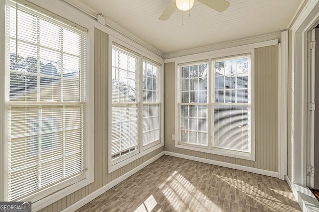unfurnished sunroom featuring ceiling fan