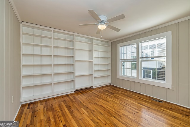 empty room with hardwood / wood-style flooring and ceiling fan
