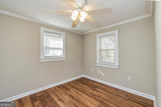 empty room featuring ceiling fan, ornamental molding, hardwood / wood-style floors, and a wealth of natural light