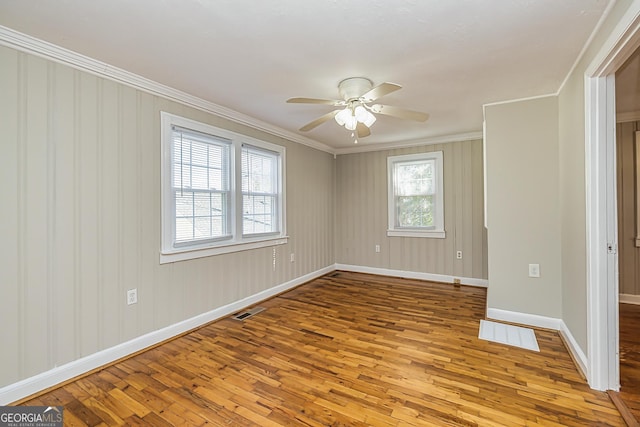 unfurnished room featuring ceiling fan, ornamental molding, and light hardwood / wood-style floors