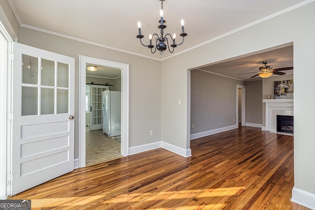 interior space with ceiling fan with notable chandelier, a barn door, a fireplace, hardwood / wood-style flooring, and ornamental molding