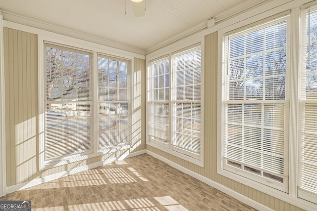 unfurnished sunroom featuring ceiling fan