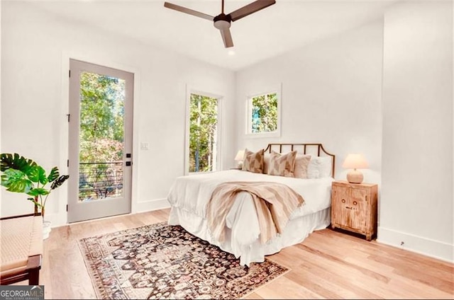 bedroom featuring ceiling fan, wood-type flooring, and access to outside