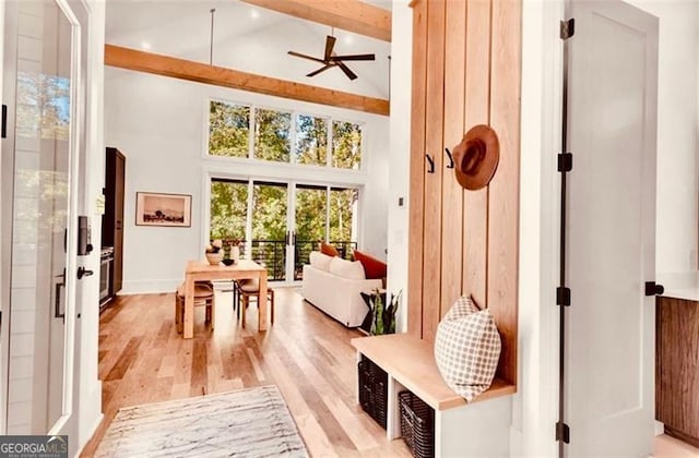 mudroom with beam ceiling, high vaulted ceiling, light hardwood / wood-style floors, and ceiling fan