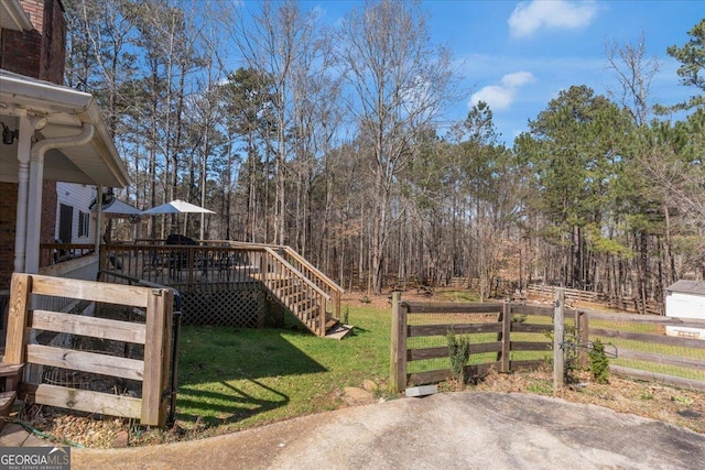 view of yard featuring stairway, fence, and a deck