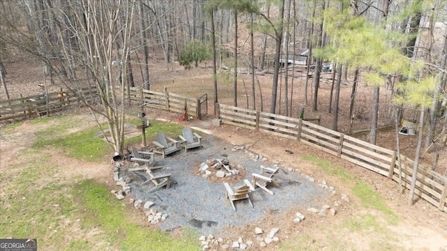 view of yard with an outdoor fire pit and fence