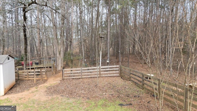 view of yard with fence and an outdoor structure