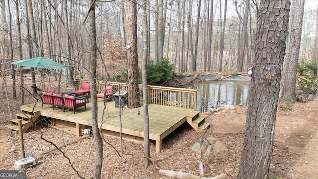 wooden terrace featuring a water view