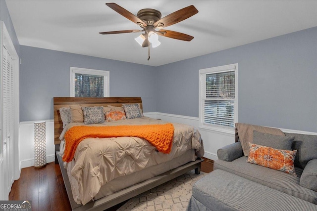 bedroom with wood-type flooring, baseboards, and ceiling fan