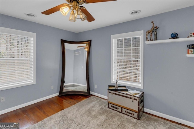 bedroom featuring wood finished floors, visible vents, and baseboards