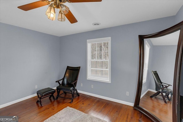 sitting room featuring visible vents, baseboards, and hardwood / wood-style floors