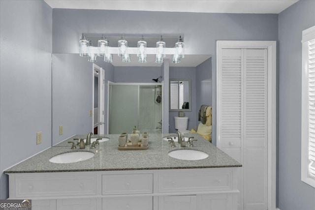 full bathroom featuring a stall shower, a closet, a sink, and toilet