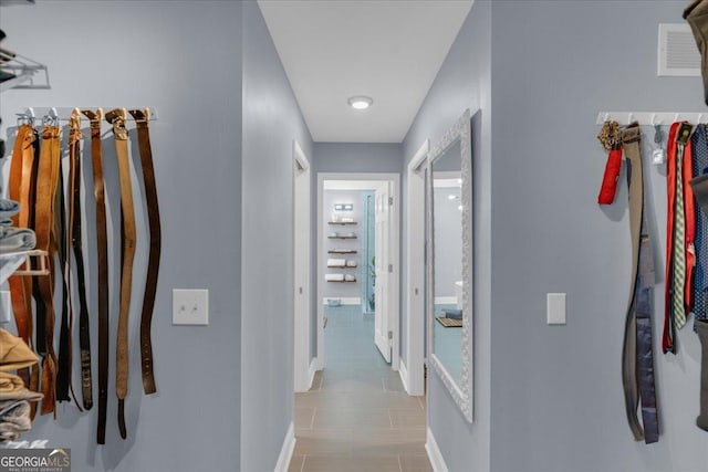 corridor featuring visible vents and baseboards