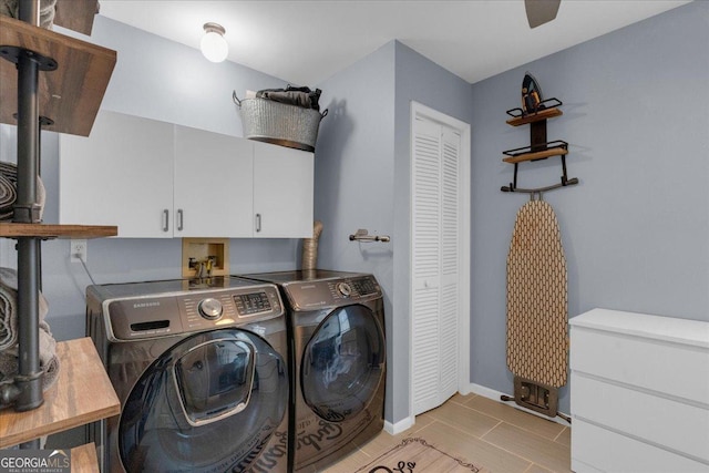 washroom with washer and clothes dryer, light tile patterned flooring, cabinet space, and baseboards