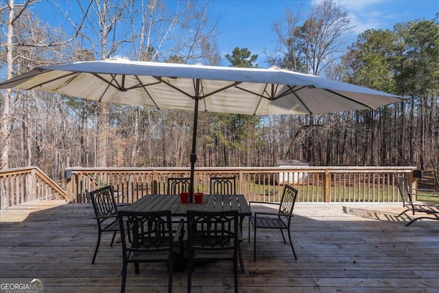 wooden terrace with outdoor dining space