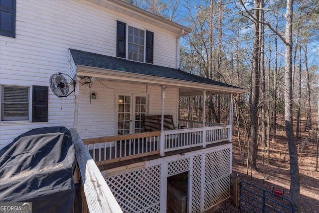 exterior space with roof with shingles