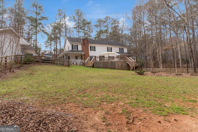 view of yard with a fenced backyard, stairway, and a deck