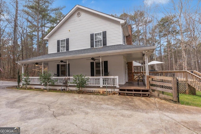 farmhouse-style home featuring ceiling fan and a porch