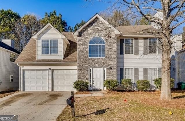 view of front of home featuring a garage, stone siding, and driveway