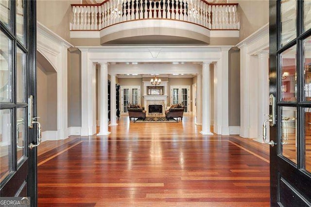 3201 Hobsons Ridge Trl NW, Acworth, GA 30101 - foyer with ornate columns, wood finished floors, a high ceiling, a fireplace, and crown molding