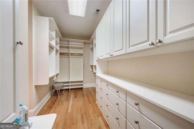 spacious closet featuring light hardwood / wood-style flooring