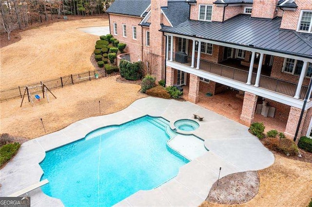 view of swimming pool with a patio and an in ground hot tub