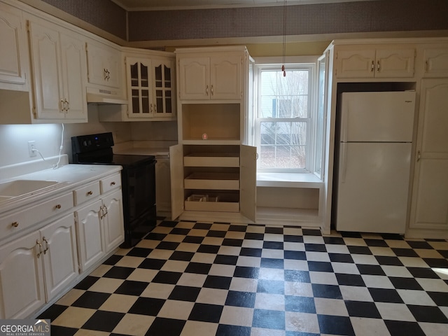 kitchen featuring white cabinets, white refrigerator, and electric range