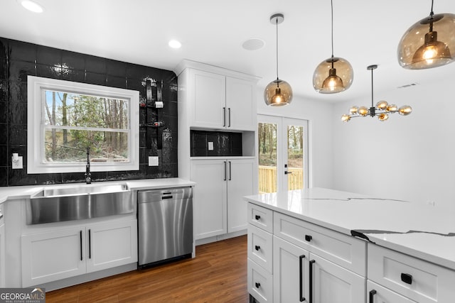 kitchen with french doors, white cabinetry, a sink, wood finished floors, and dishwasher