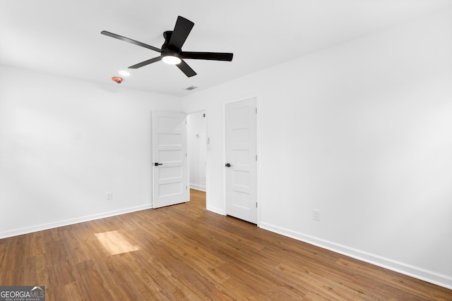 unfurnished bedroom featuring a ceiling fan, baseboards, and wood finished floors