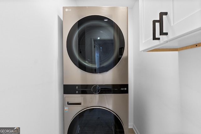 laundry area with laundry area and stacked washer and clothes dryer