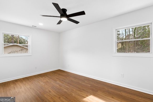 spare room with ceiling fan, recessed lighting, wood finished floors, visible vents, and baseboards