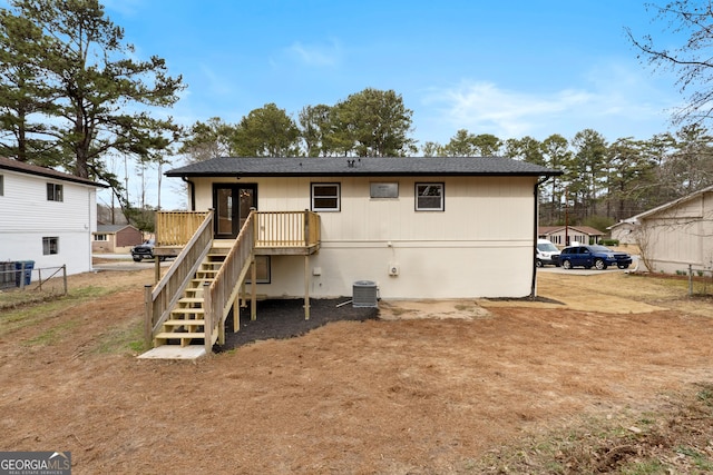 back of house featuring a deck, central AC unit, stairway, and fence