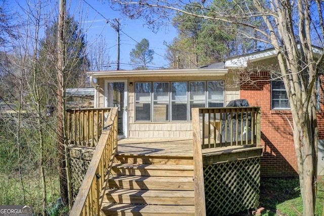 wooden terrace featuring a sunroom