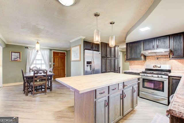 kitchen with light hardwood / wood-style floors, dark brown cabinets, stainless steel appliances, and a kitchen island