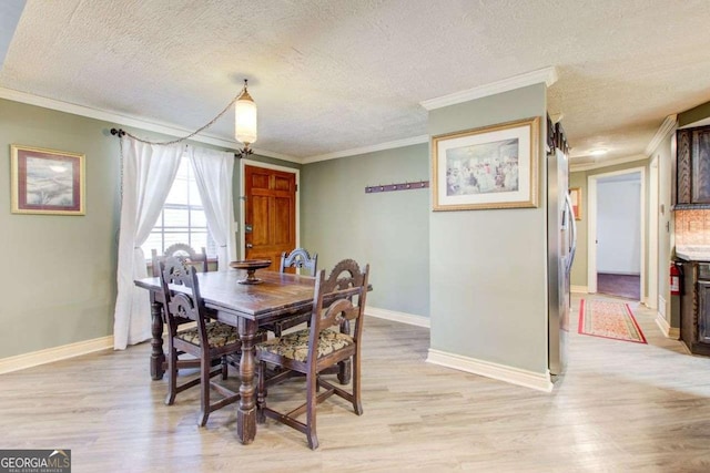 dining area with light wood-type flooring, crown molding, and a textured ceiling