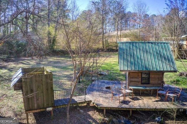 exterior space featuring a deck and an outdoor fire pit