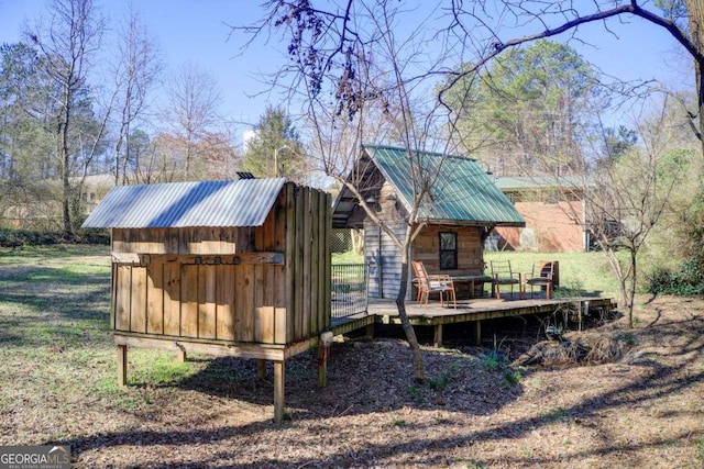 exterior space with a deck and an outdoor structure