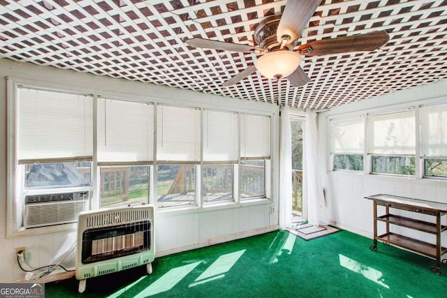 unfurnished sunroom with cooling unit, heating unit, and ceiling fan